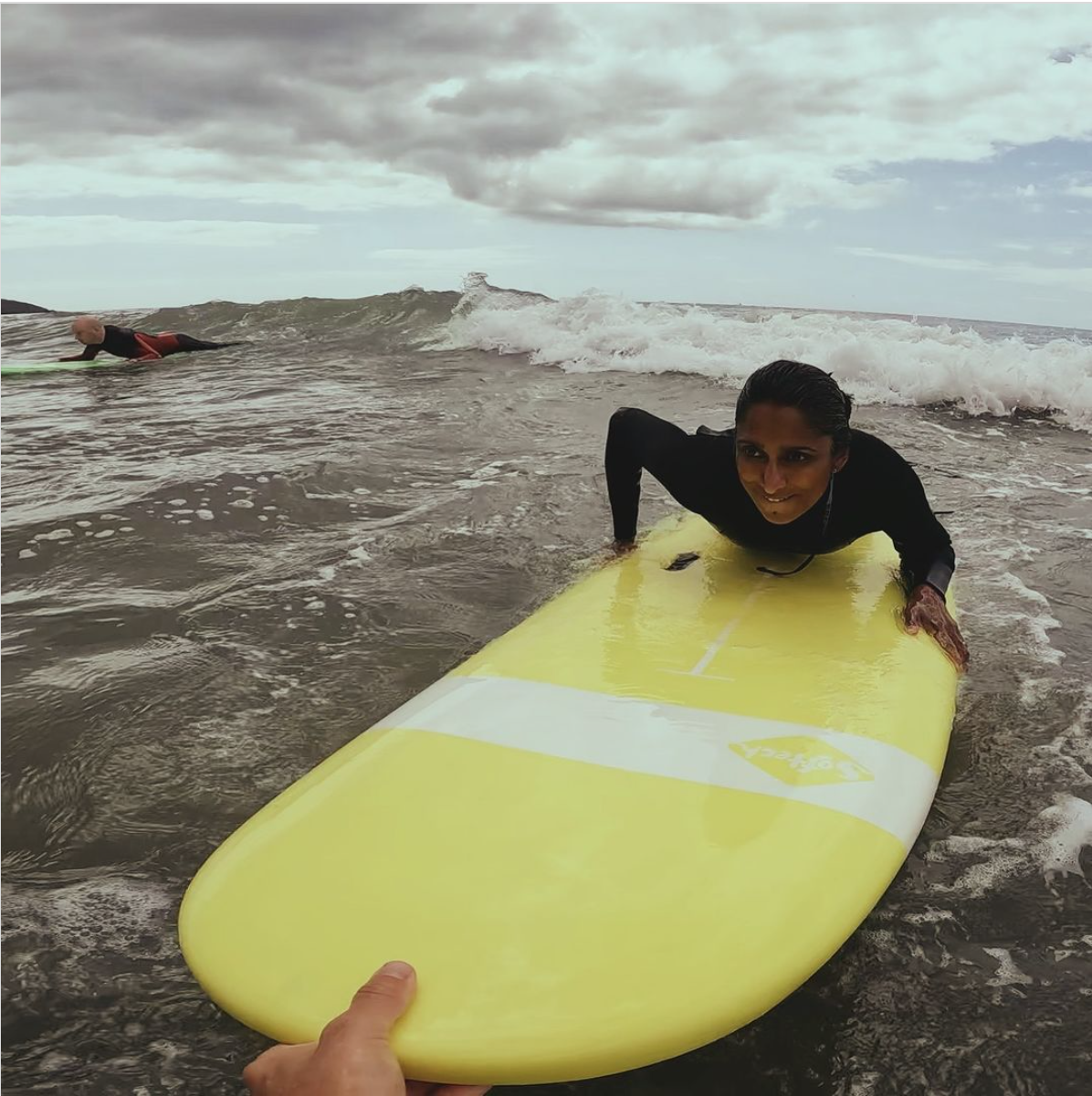 woman learning to surf in Cornwall